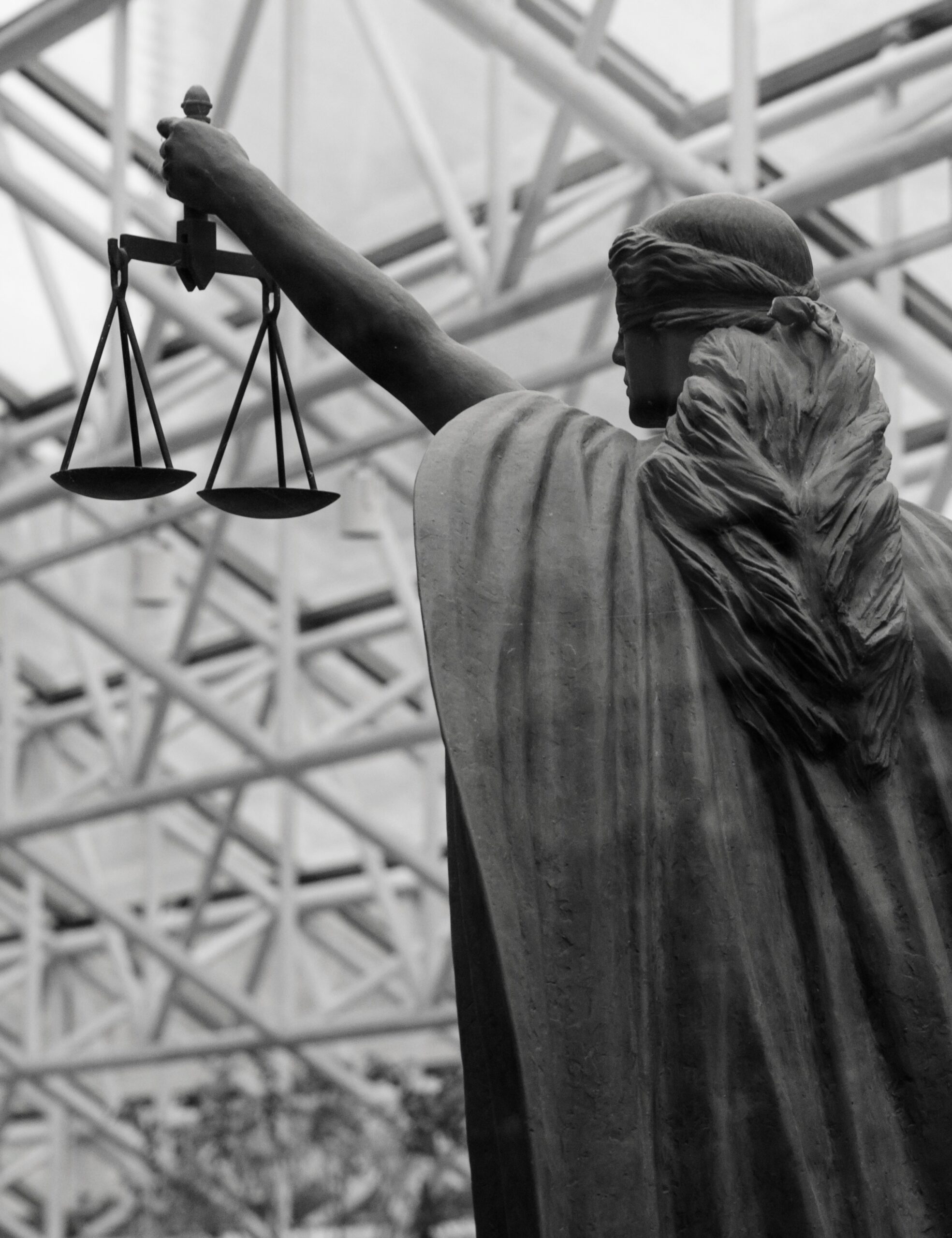 Blindfolded statue of Justice holding scales